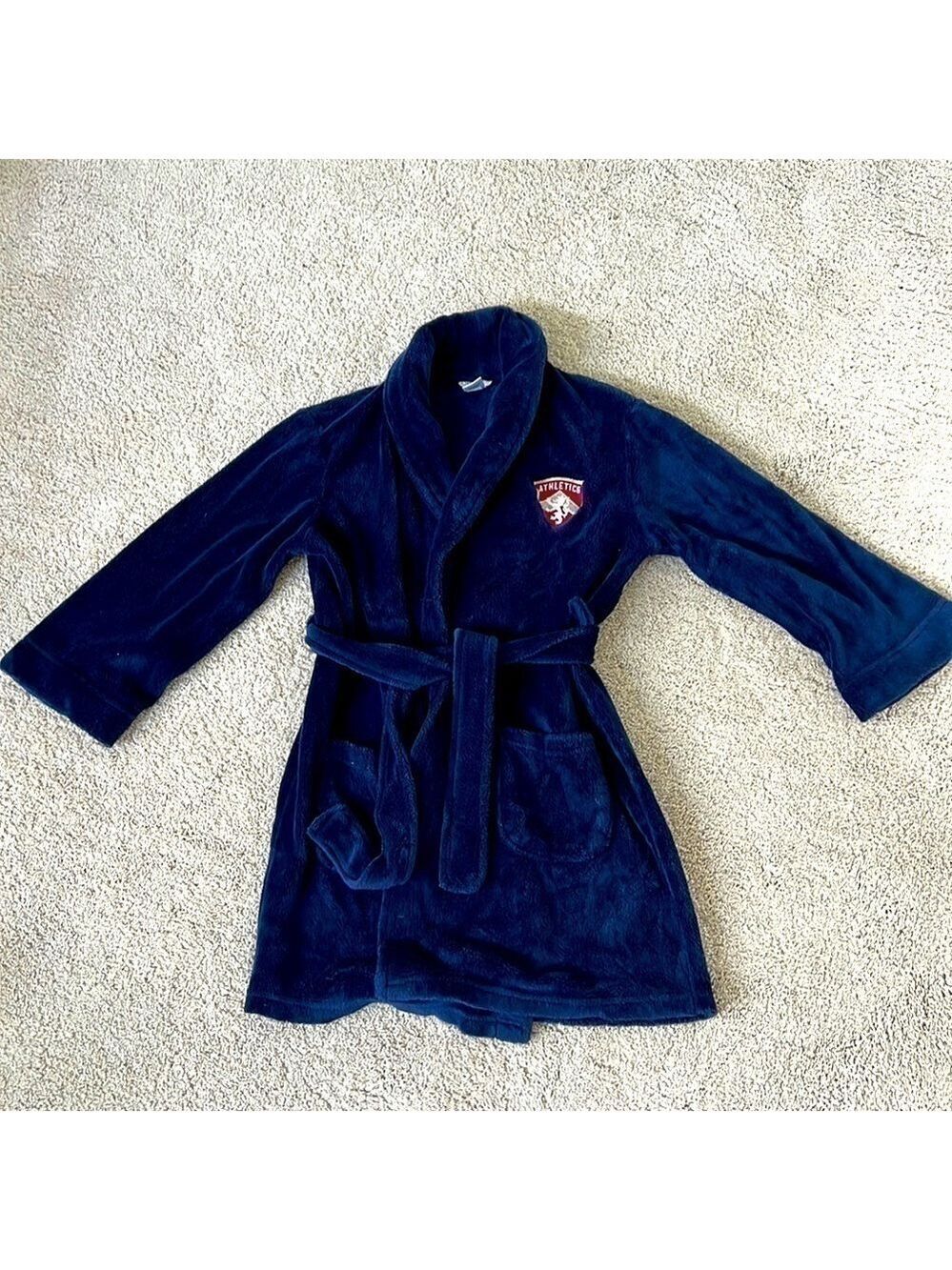 Boys Cherokee navy robe with red and silver crest. Size M